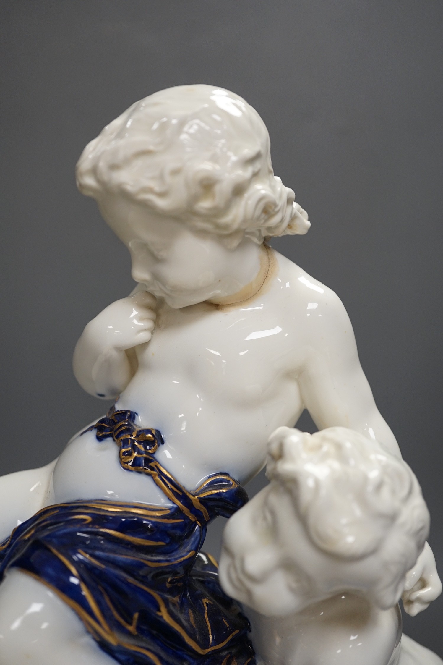 A Copeland porcelain putti seated on a shell centrepiece, modelled O. Hale, c.1877, 35cms high
